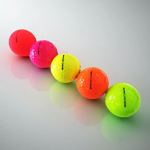 Colorful golf balls on a reflective surface with a white background