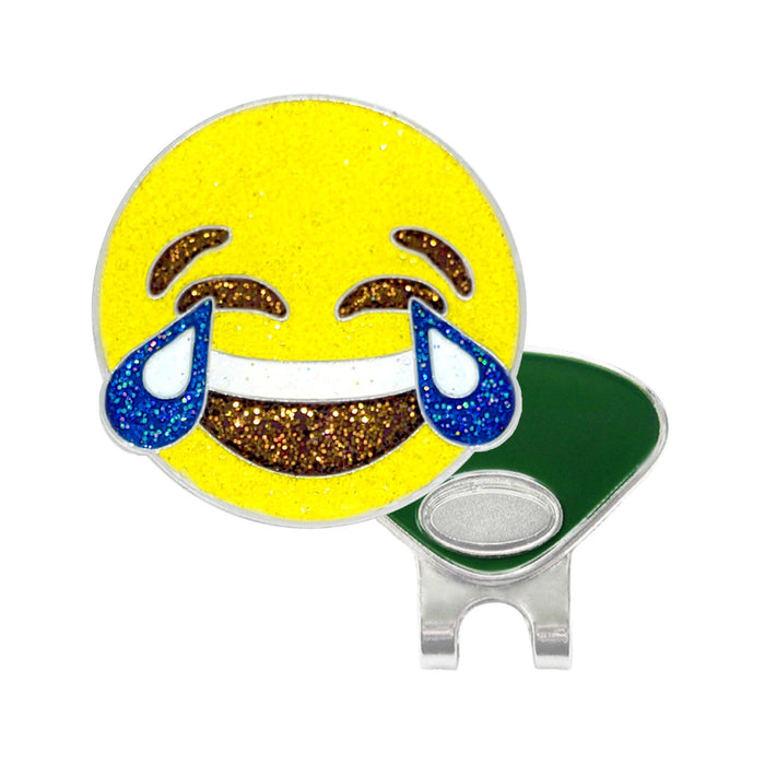 Emoticon emoji with teary eyes on a yellow background, attached to a golf ball marker with a clip.