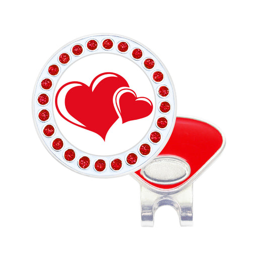 Golf ball marker with red hearts and red gemstones on a white background