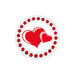 Circular object with red heart design and red embellishments on a white background