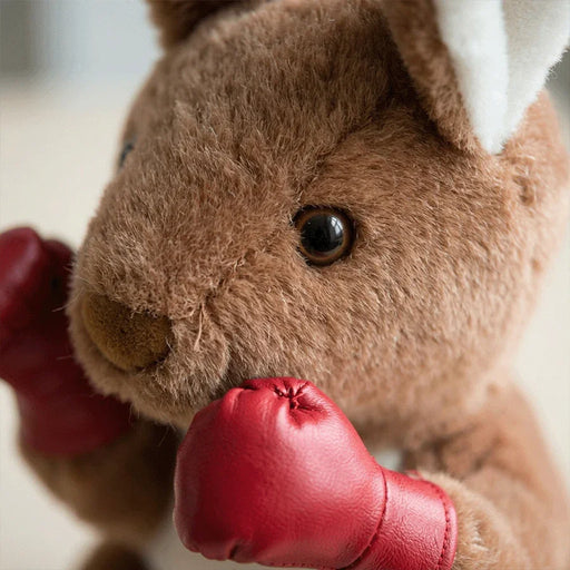 Close-up of a plush kangaroo toy with red boxing gloves.