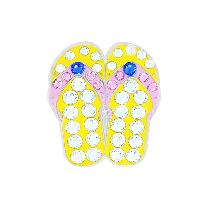 Yellow flip-flop with rhinestones on a white background