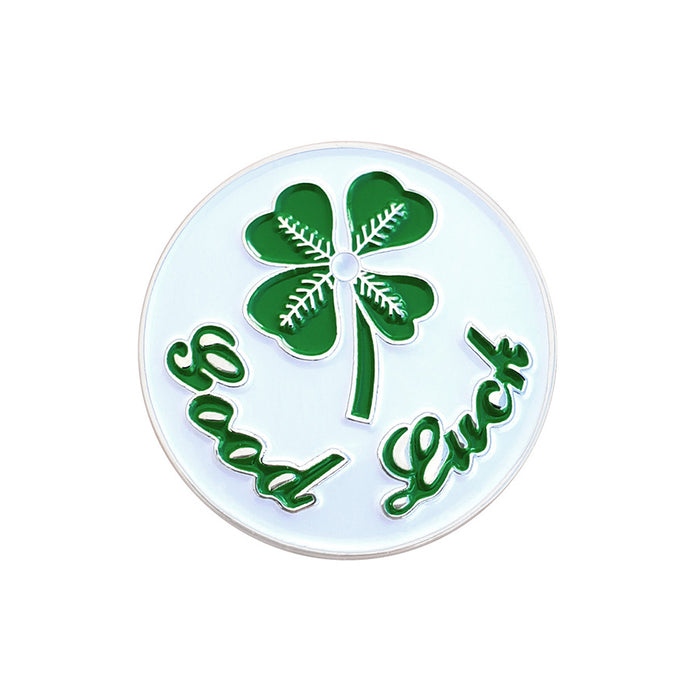 Circular object with a four-leaf clover and 'Good Luck' text on a white background