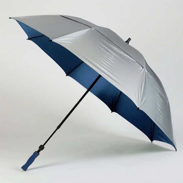 A silver and navy blue golf umbrella with a black shaft and a blue grip handle, shown open on a light gray background.