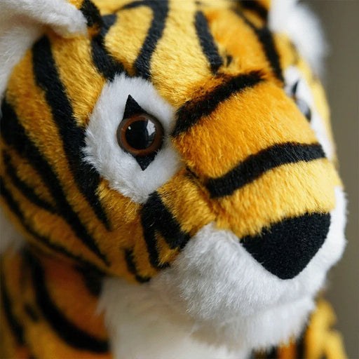 Close-up of a plush tiger golf headcover with detailed stripes and white fur.