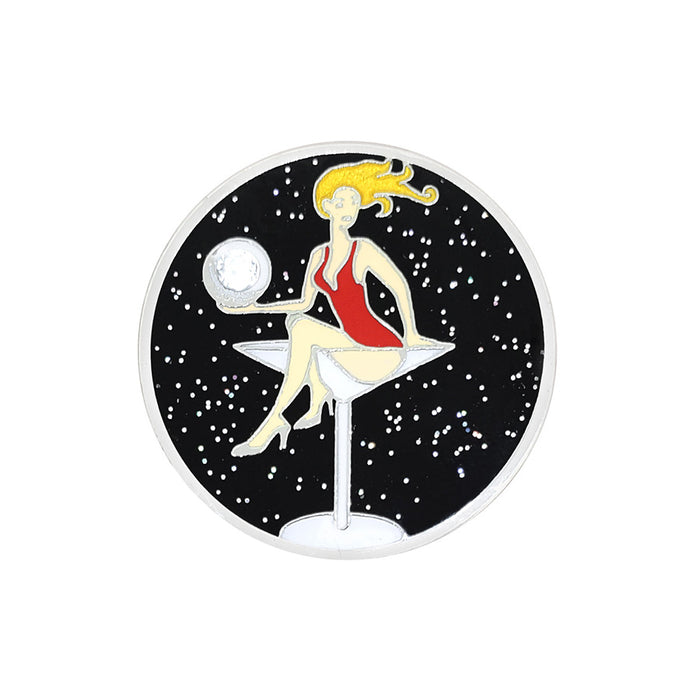 Decorative coaster with a design of a woman in a red dress sitting on a cocktail glass against a black background with white specks.