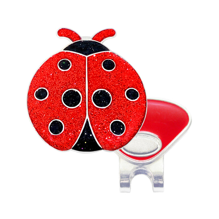 Red ladybug-shaped object with a clip on a white background