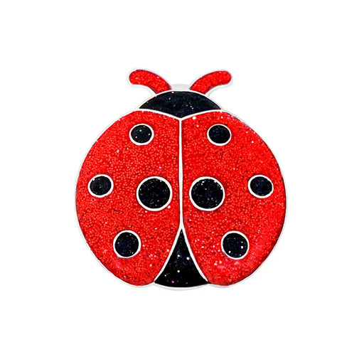 Red ladybug Navika golf marker with black spots on a white background