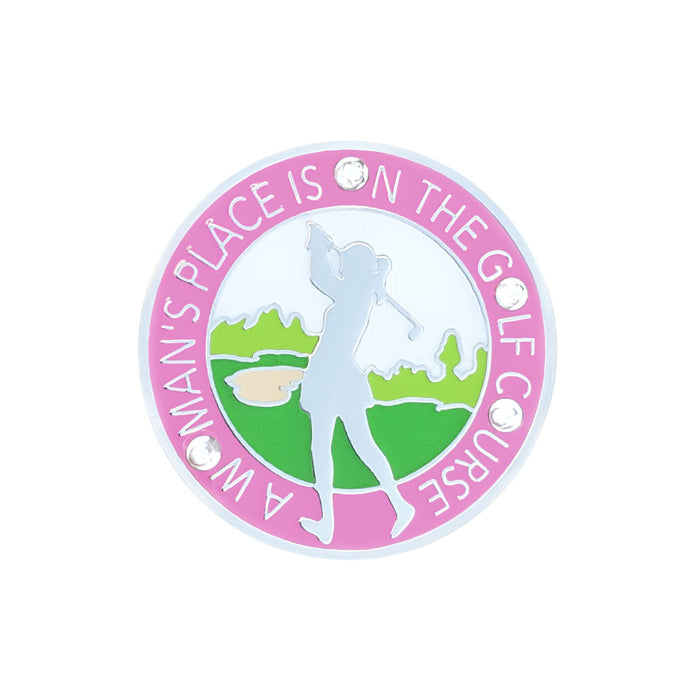 Circular badge with a silhouette of a woman playing golf, text 'A Woman's Place is on the Golf Course', and pink border.