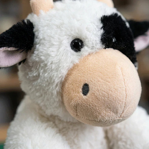 Close-up of a plush cow headcover with a blurred background