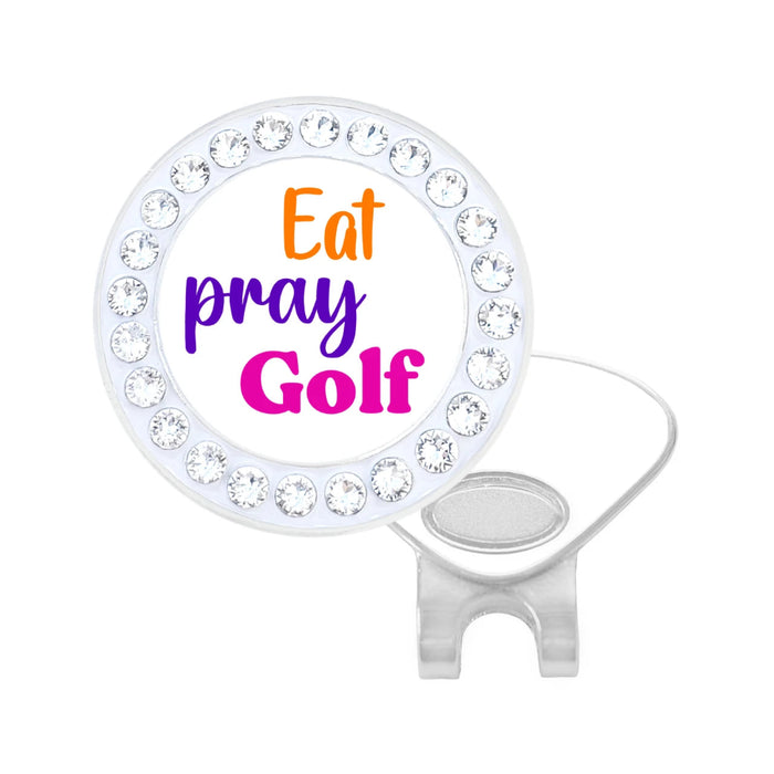 A white ball marker with a circular head adorned with clear swarovski crystals and printed with the text 'Eat pray golf' in orange, purple, and pink lettering, shown on a plain white background