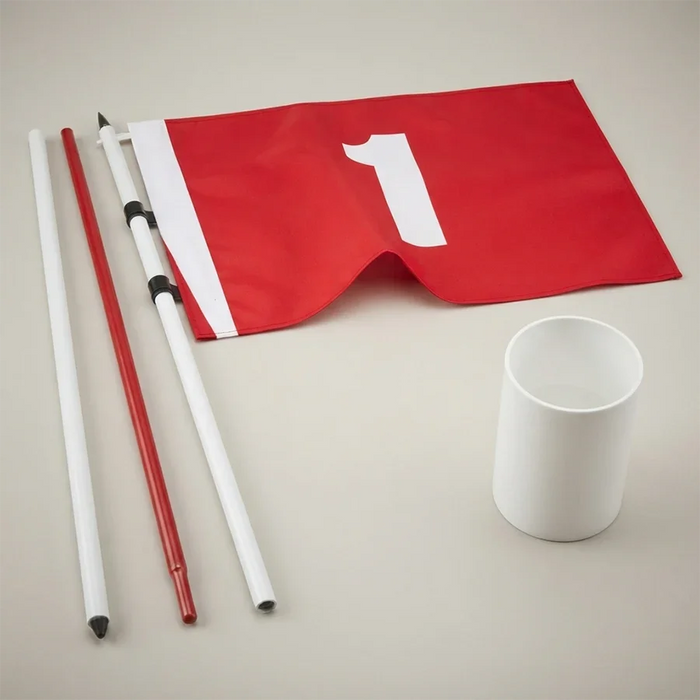 A red flag with a white number 1 on a white pole, shown with additional white and red poles and a white cup on a light beige background.