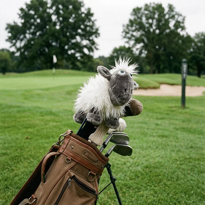 Golf club with a plush sheep head cover on a golf course
